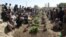 The victims of a deadly mosque attack, Aug. 3, 2018, in Gardez, the capital of Paktia province, eastern Afghanistan, were buried in a common grave Saturday under tight security.