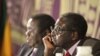 Zimbabwean President Robert Mugabe (r) with Prime Minister Morgan Tsvangirai in Harare, Nov. 11, 2011.