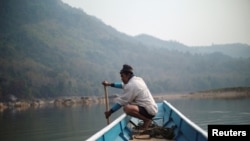 A local villager drive a boat where the future site of the Luang Prabang dam will be on the Mekong River, outskirt of Luang Prabang province, Laos, February 5, 2020. REUTERS/Panu Wongcha-um