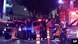 Police and medics stand at the scene of an officer involved shooting in front of a federal courthouse after a Black Lives Matter protest Tuesday, June 2, 2020, in Las Vegas. (AP Photo/John Locher)