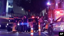 Police and medics stand at the scene of an officer involved shooting in front of a federal courthouse after a Black Lives Matter protest, June 2, 2020, in Las Vegas.