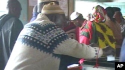 A man casts his ballot in during Kenya's constitutional referendum