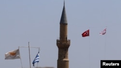 Cyprus and Greek flags along with Turkish and Turkish Cypriot flags are seen near the U.N.-controlled buffer zone in Nicosia, Cyprus July 6, 2017.