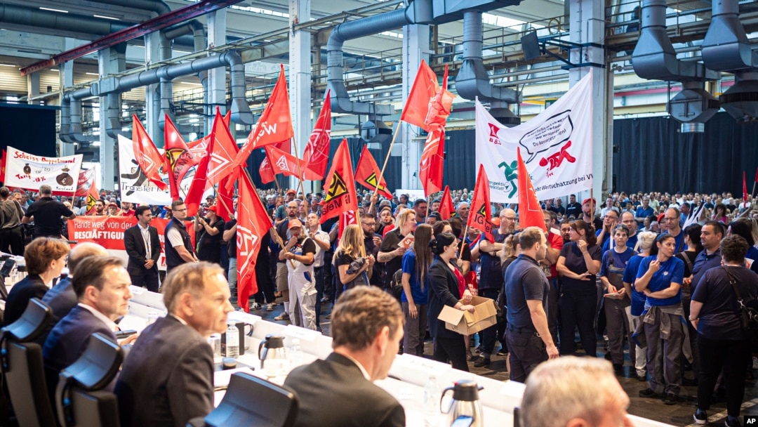 Employees protest before the start of a works meeting in a hall at the VW plant in Wolfsburg, Sept. 4, 2024. Volkswagen has announced that it will tighten its austerity measures due to the tense situation of the core brand.