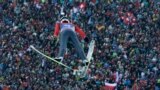 Switzerland&#39;s Simon Ammann soars during his first jump at the second stage of the four hills ski jumping tournament in Garmisch-Partenkirchen, Germany.