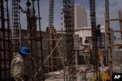 FILE - Workers labor under the sun amid high heat during their workday at a construction site in the city of Veracruz, Mexico, on June 17, 2024.