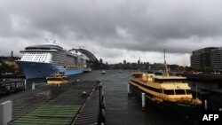 Heavy clouds cover Sydney Harbor, Nov. 28, 2018. Flights were cancelled, railway lines closed and motorists stranded on flooded roads as a month's worth of rain fell on Sydney.