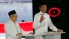 Indonesian President Joko Widodo, right, delivers a speech with running mate Ma'ruf Amin during a televised presidential candidates debate in Jakarta, Indonesia, April 13, 2019. 