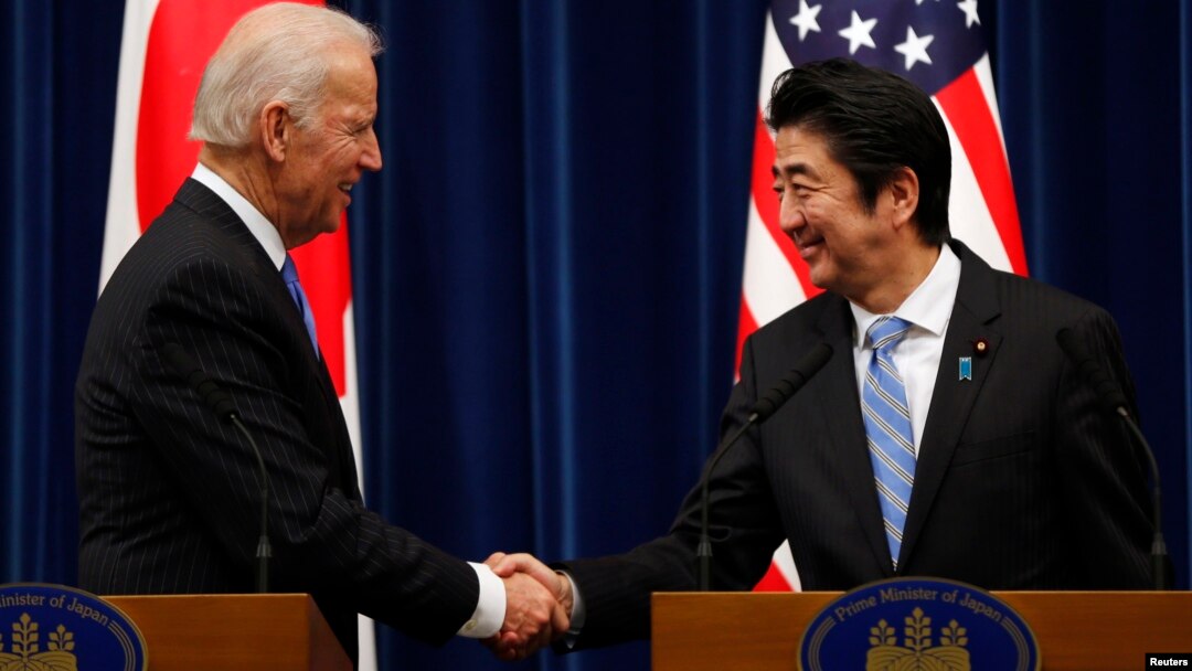 U.S. Vice President Joe Biden (L) shakes hands with Japan's Prime Minister Shinzo Abe at the end of their joint news conference following their meeting at the prime minister's official residence in Tokyo, Dec. 3, 2013. Biden urged Japan and China to lower