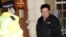 Myanmar's Ambassador to the United Kingdom, Kyaw Zwar Minn, stands with police officers locked outside the Myanmar Embassy in London on April 7, 2021. - Myanmar's ambassador in Britain on Wednesday said a Yangon miltary-linked figure had "occupied" the em