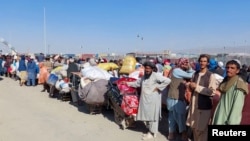 Afghan citizens wait with their belongings to cross into Afghanistan, after Pakistan gives the last warning to undocumented immigrants to leave, at the Friendship Gate of Chaman Border Crossing in Chaman, Pakistan, Oct. 31, 2023. 