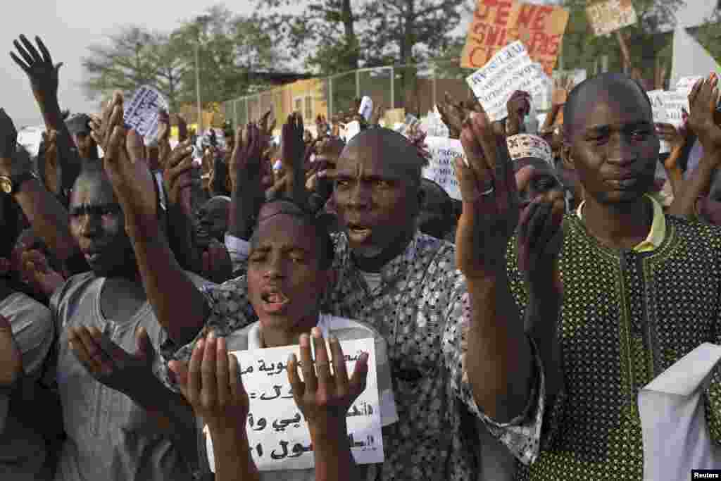 People pray during a rally against French satirical weekly Charlie Hebdo, which featured a cartoon of the Prophet Muhammad as the cover of its first edition since an attack by Islamist gunmen, in Bamako, Mali.