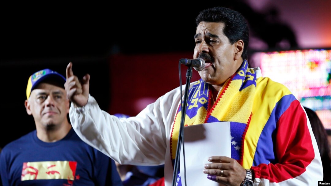 Venezuela's President Nicolas Maduro talks to supporters during a meeting at Plaza Bolivar in Caracas, Dec. 8, 2013.