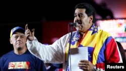 Venezuela's President Nicolas Maduro talks to supporters during a meeting at Plaza Bolivar in Caracas, Dec. 8, 2013.