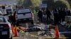 FILE - Police officers and rescue personnel stand near the bodies of people who were killed in a car crash on the outskirts of Puebla, Mexico, Dec. 12, 2017.