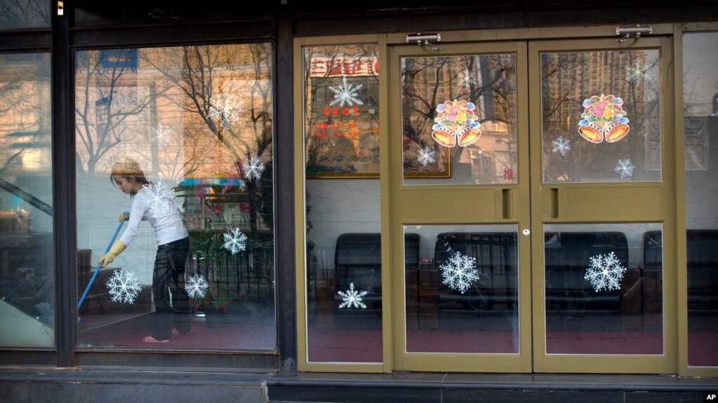 A worker sweeps inside a branch of the North Korean-operated restaurant in Beijing. China has said it has ordered North Korean businesses in China to close by early 2018.