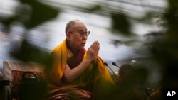 Dalai Lama prays during Ganden Ngachoe, the death anniversary of 14th Century Tibetan Saint-Scholar, Lama Tsongkhapa in New Delhi, Dec. 16, 2014.