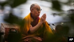 FILE - The Dalai Lama prays during Ganden Ngachoe, the death anniversary of 14th Century Tibetan Saint-Scholar, Lama Tsongkhapa, in New Delhi, India.