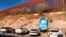 FILE - This is the boundary between the U.S. and Mexico at Nogales, Mexico, Dec. 4, 2017. The poster is of Juan Antonio Elena Rodriguez, a teen who was shot and killed by a Border Patrol agent who shot through the fence in 2010. 