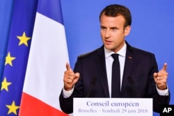 FILE - French President Emmanuel Macron speaks during a media conference at an EU summit in Brussels, June 29, 2018.