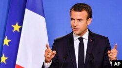 FILE - French President Emmanuel Macron speaks during a media conference at an EU summit in Brussels, June 29, 2018. 