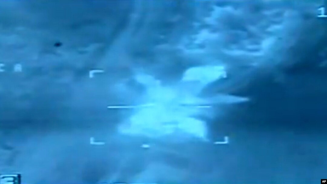 FILE - An image taken from aerial footage shows a target hit by an airstrike in Libya.