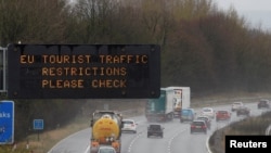 A motorway sign warning drivers about EU traffic restrictions is seen on the M56 motorway near Liverpool, Britain March 18, 2020. 