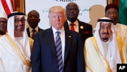 FILE - President Donald Trump poses for photos with King Salman and others at the Arab Islamic American Summit, at the King Abdulaziz Conference Center, May 21, 2017, in Riyadh, Saudi Arabia.