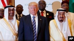 President Donald Trump poses for photos with King Salman, right, and others at the Arab Islamic American Summit, at the King Abdulaziz Conference Center, May 21, 2017, in Riyadh, Saudi Arabia.