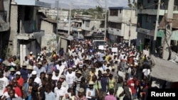Protesters called up to demonstrate by opposition groups march in Port-au-Prince, Haiti, Feb. 12, 2016.