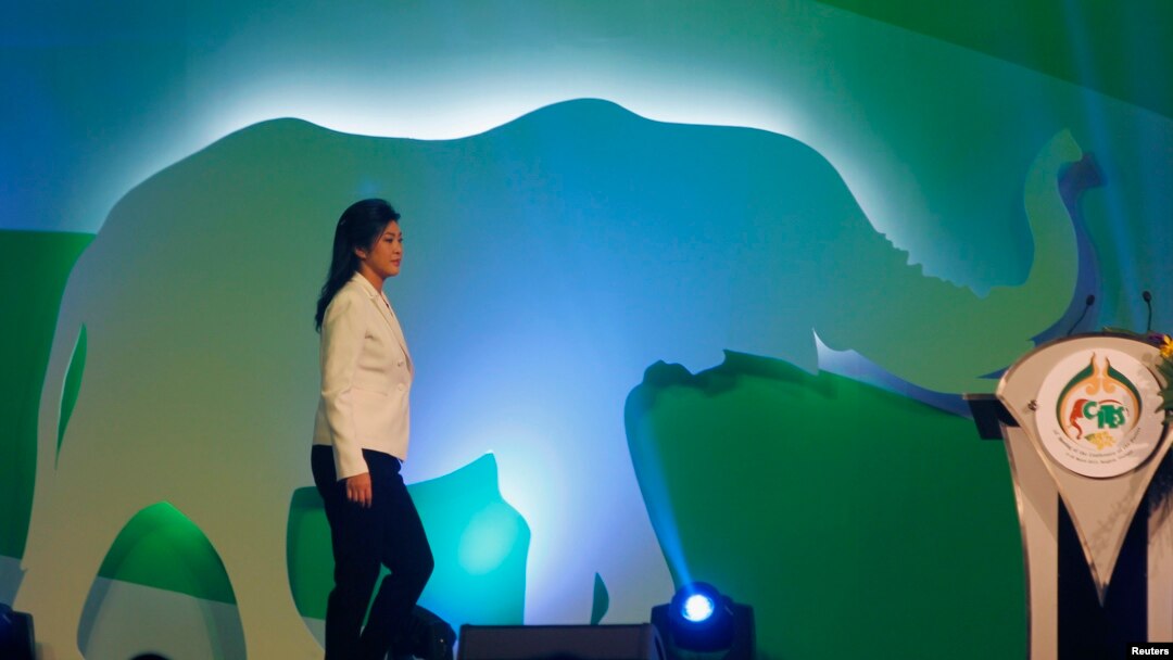 Thailand's Prime Minister Yingluck Shinawatra is seen walking on stage before opening the CITES meeting in Bangkok March 3, 2013.