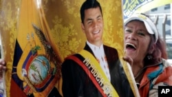 A supporter of Ecuador's former President Rafael Correa, in poster, shouts in favor of jailed, former Vice President Jorge Glas outside the National Court where Glas is meeting with his lawyer before the country's highest court in Quito, Ecuador, Oct. 15, 2017.