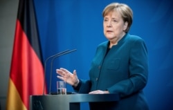 FILE - German Chancellor Angela Merkel speaks at a press conference about coronavirus, in Berlin, March 22, 2020.