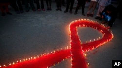 FILE - Candles are lit on the eve of World AIDS Day in Kathmandu, Nepal, Nov. 30, 2016.