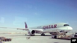 FILE - A parked Qatari plane in Hamad International Airport in Doha, Qatar, June 6, 2017. The United Arab Emirates orchestrated the hacking of a Qatari government news site in May, planting a false story that was used as a pretext for the current crisis between Qatar and several Arab countries, according to a report Sunday, July 16, by The Washington Post. In early June, Saudi Arabia, the United Arab Emirates, Bahrain and Egypt cut ties with Qatar and moved to isolate the small, but wealthy Gulf nation, canceling air routes between their capitals and Qatar's and closing their airspace to Qatari flights.