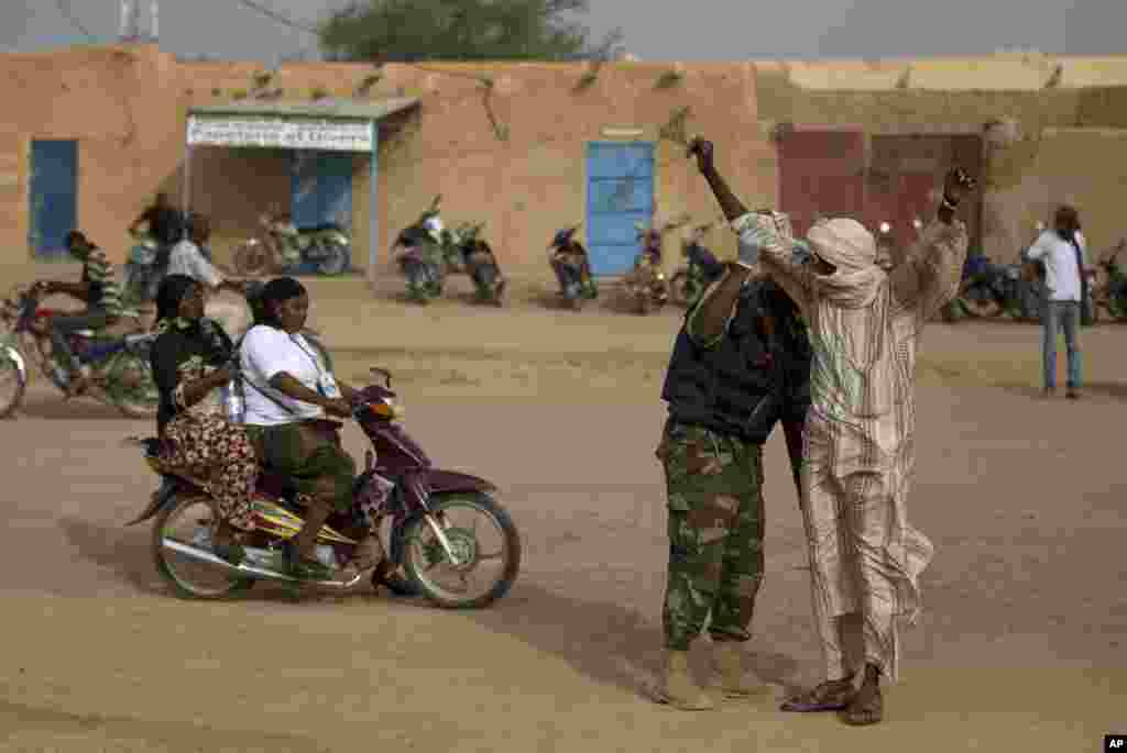 A man is patted down by a United Nations peacekeeper outside the main polling place in Kidal, Mali, July 28, 2013.&nbsp;