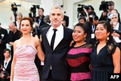 (From L) Actress Marina de Tavira, director Alfonso Cuaron, actress Yalitza Aparicio and actress Nancy Garcia arrive for the premiere of the film "Roma" presented in competition, Aug. 30, 2018, during the 75th Venice Film Festival at Venice Lido.