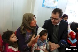 German Minister of Economic Cooperation and Development Gerd Mueller visits Syrian refugees, at the Domiz refugee camp in the northern Iraqi province of Dohuk, Jan. 28, 2016.