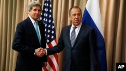U.S. Secretary of State John Kerry, left, shakes hands with Russian Foreign Minister Sergey Lavrov at a bilateral meeting to discuss the ongoing situation in Ukraine, April 17, 2014.