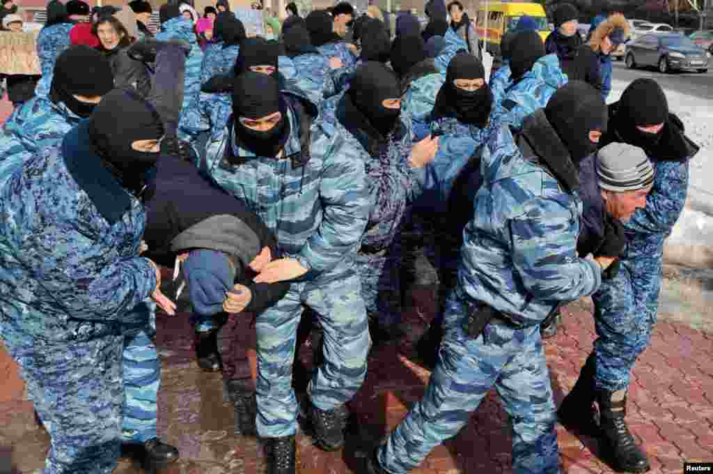 Kazakh law enforcement officers detain protesters during a rally held by opposition supporters, after anti-government activist has died of heart problems in a police detention center earlier this week, in Nur-Sultan, Kazakhstan.