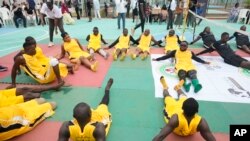 FILE — Peacemaker Azuegbulam, 27, Africa's first gold medalist at the Invictus Games, center left, warms up before an exhibition sitting volleyball match in Abuja Nigeria, May 11, 2024.