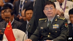 FILE - China's Defense Minister Chang Wanquan, right, sits before the start of an Association of Southeast Asian Nations (ASEAN) Defense Ministers' meeting in Kuala Lumpur, Malaysia, Nov. 4, 2015.