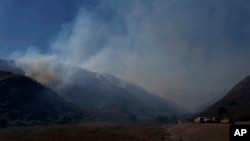 Firefighters keep watch on hot spots from the Sharp Fire in Simi Valley, Wednesday, July 3, 2024. 