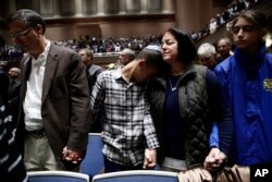 People mourn in Soldiers & Sailors Memorial Hall & Museum during a community gathering held in the aftermath of Saturday's deadly shooting at the Tree of Life Synagogue in Pittsburgh, Oct. 28, 2018.