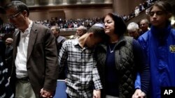 People mourn in Soldiers & Sailors Memorial Hall & Museum during a community gathering held in the aftermath of Saturday's deadly shooting at the Tree of Life Synagogue in Pittsburgh, Sunday, Oct. 28, 2018. 