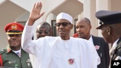 Nigeria President Muhammadu Buhari, waves after a meeting in Abuja, Nigeria, Jan. 9, 2017. Officials say Nigeria's President Muhammadu Buhari will lead three West African heads of state to Gambia on Wednesday in an effort to persuade its longtime leader t