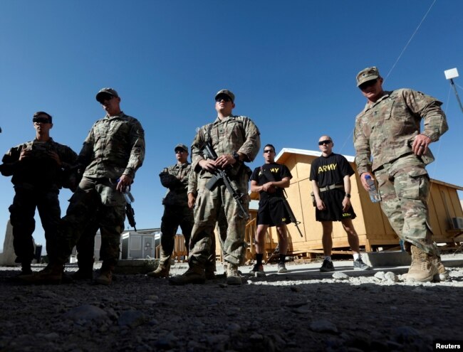 FILE - U.S. troops listen to a security briefing before leave their base in Logar province, Afghanistan, Aug. 5, 2018.