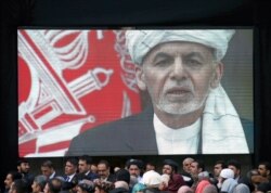 A screen shows the broadcast of Afghanistan's President Ashraf Ghani speaking during his inauguration as president, in Kabul, Afghanistan, March 9, 2020.