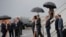 U.S. President Barack Obama and his wife Michelle approach Cuba's foreign minister Bruno Rodriguez as they arrive at Havana's international airport, March 20, 2016. 
