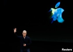 FILE - Apple CEO Tim Cook waves at the end of an Apple media event in Cupertino, California, Oct. 27, 2016.